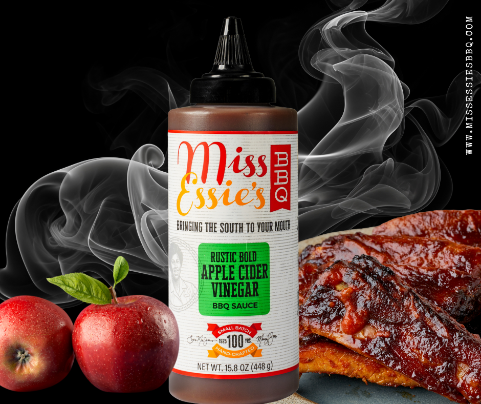 Miss Essie’s Rustic Bold Apple Cider Vinegar BBQ Sauce bottle front and center, flanked by fresh apples and sauced ribs.