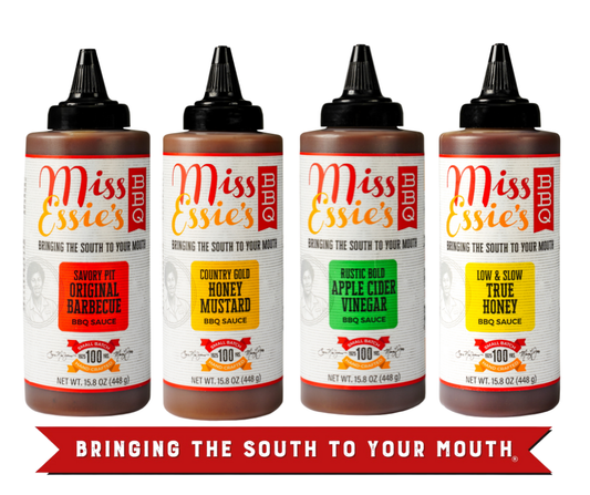 Four bottles of Miss Ellie's sauces with labels for different flavors on a white background.